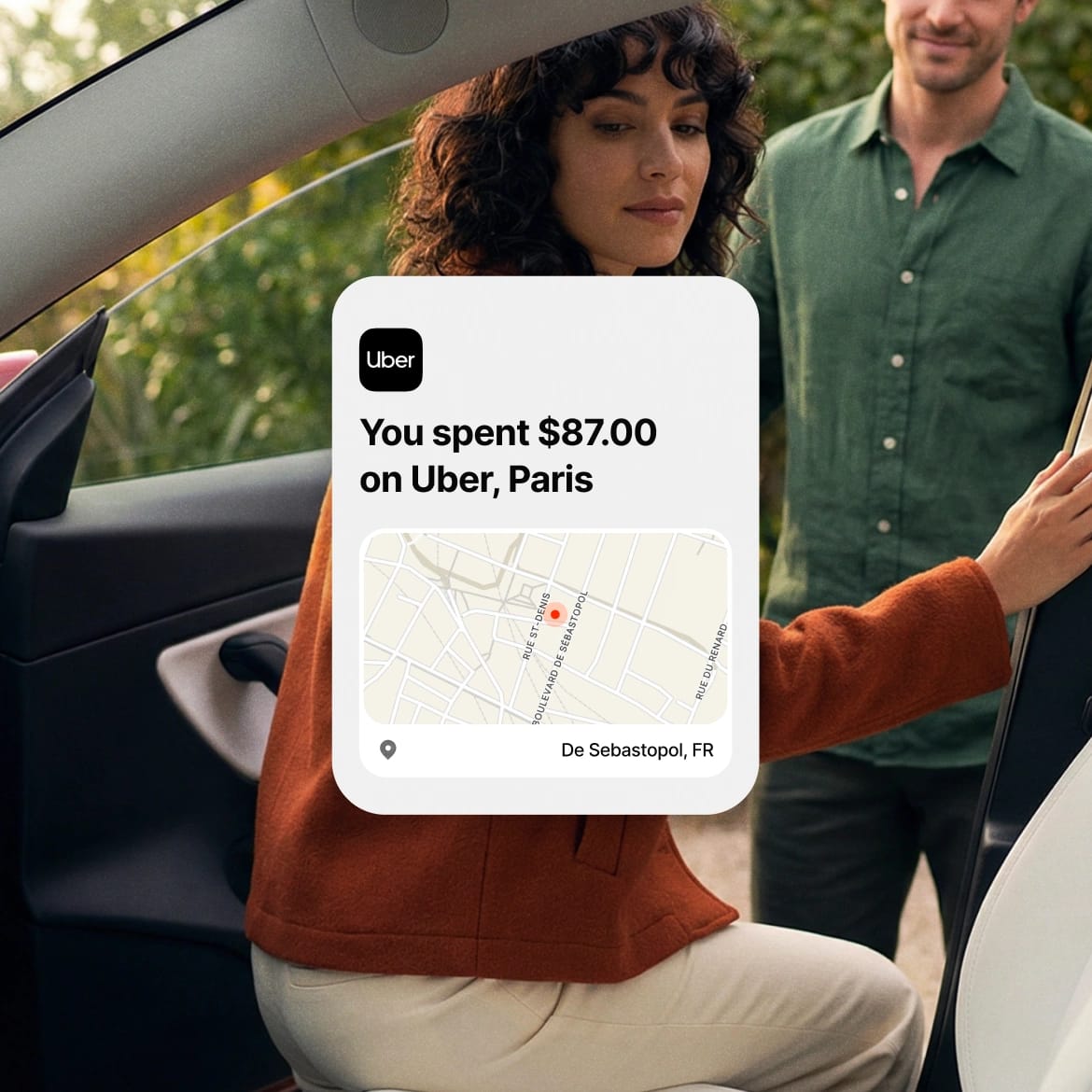 Woman stepping out of a car in Paris with an $87 Uber transaction receipt